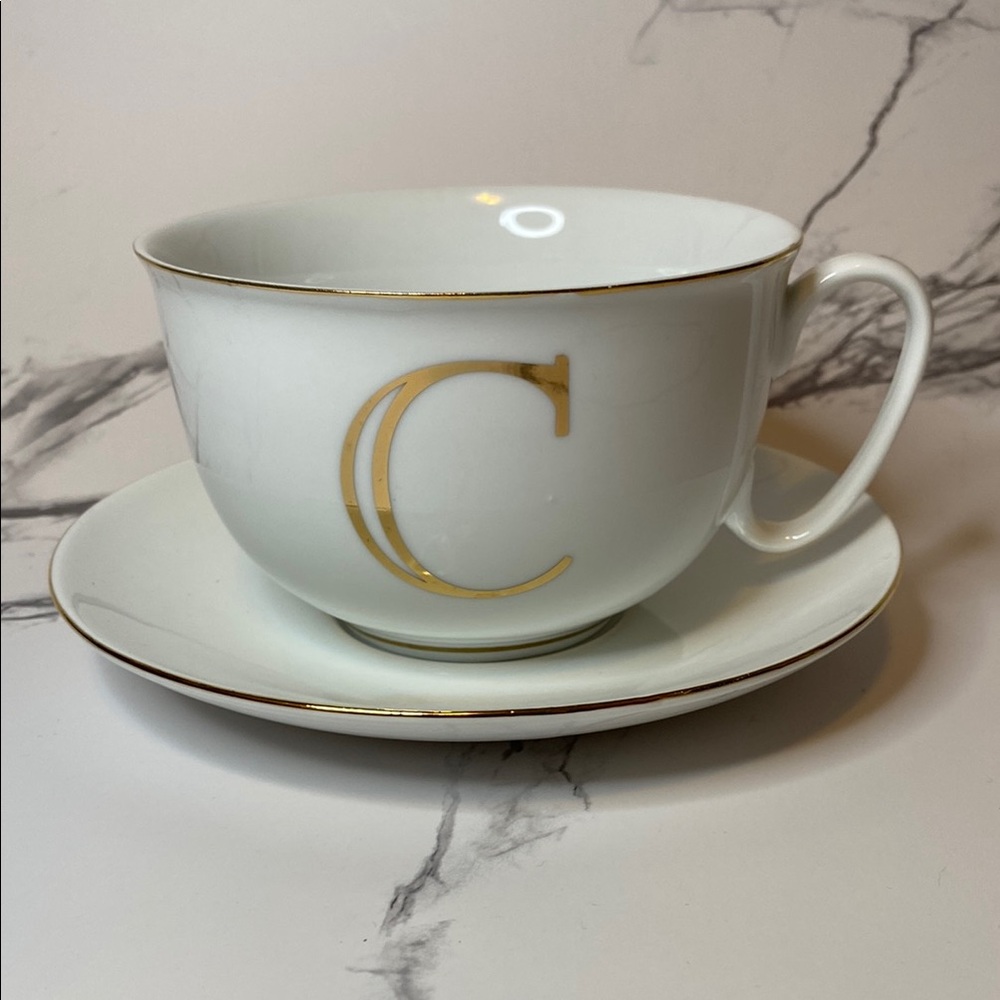 White Teacup and Saucer with Gold Lettering